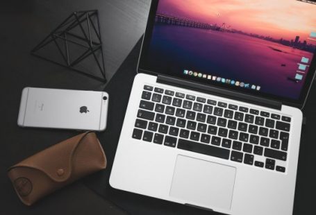 Mobile Programming - MacBook Pro beside space iPhone 6 on black wooden surface