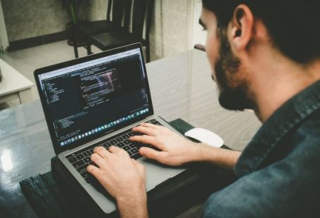 Programmer - man programming using laptop