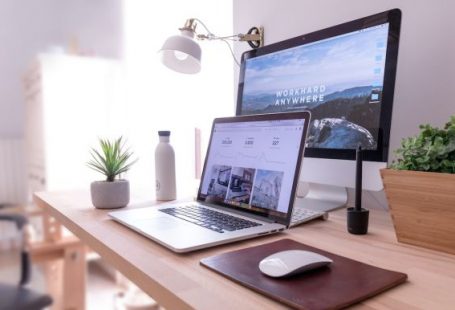 Web Development - MacBook Pro on table beside white iMac and Magic Mouse